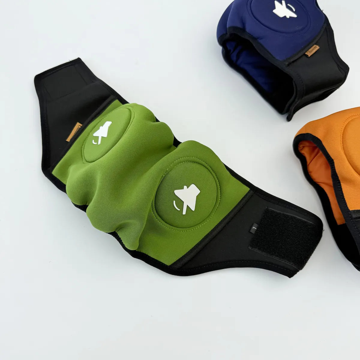 Green dog calming headgear with ear muffs, flat view