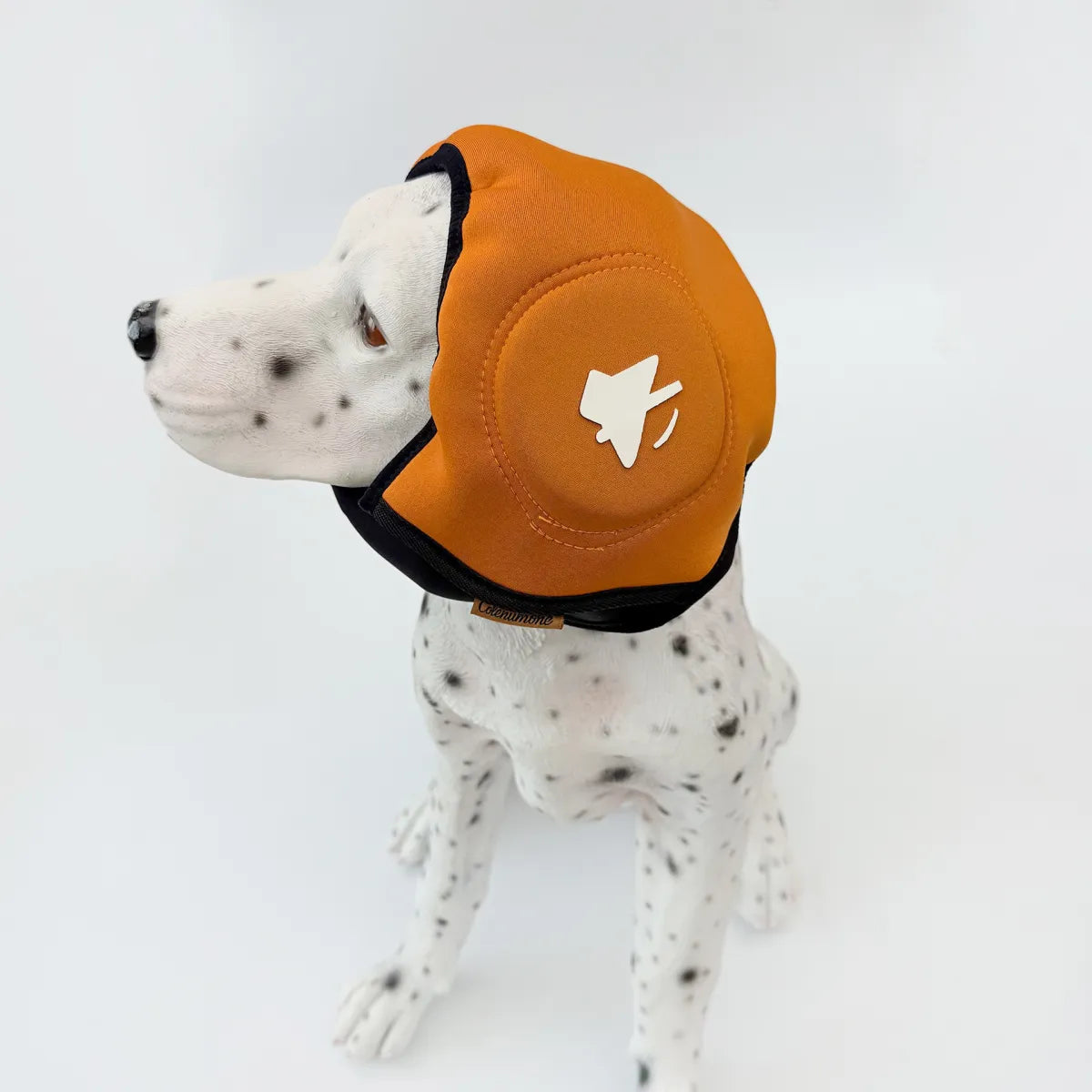 Dog wearing orange adjustable calming ear muff headgear